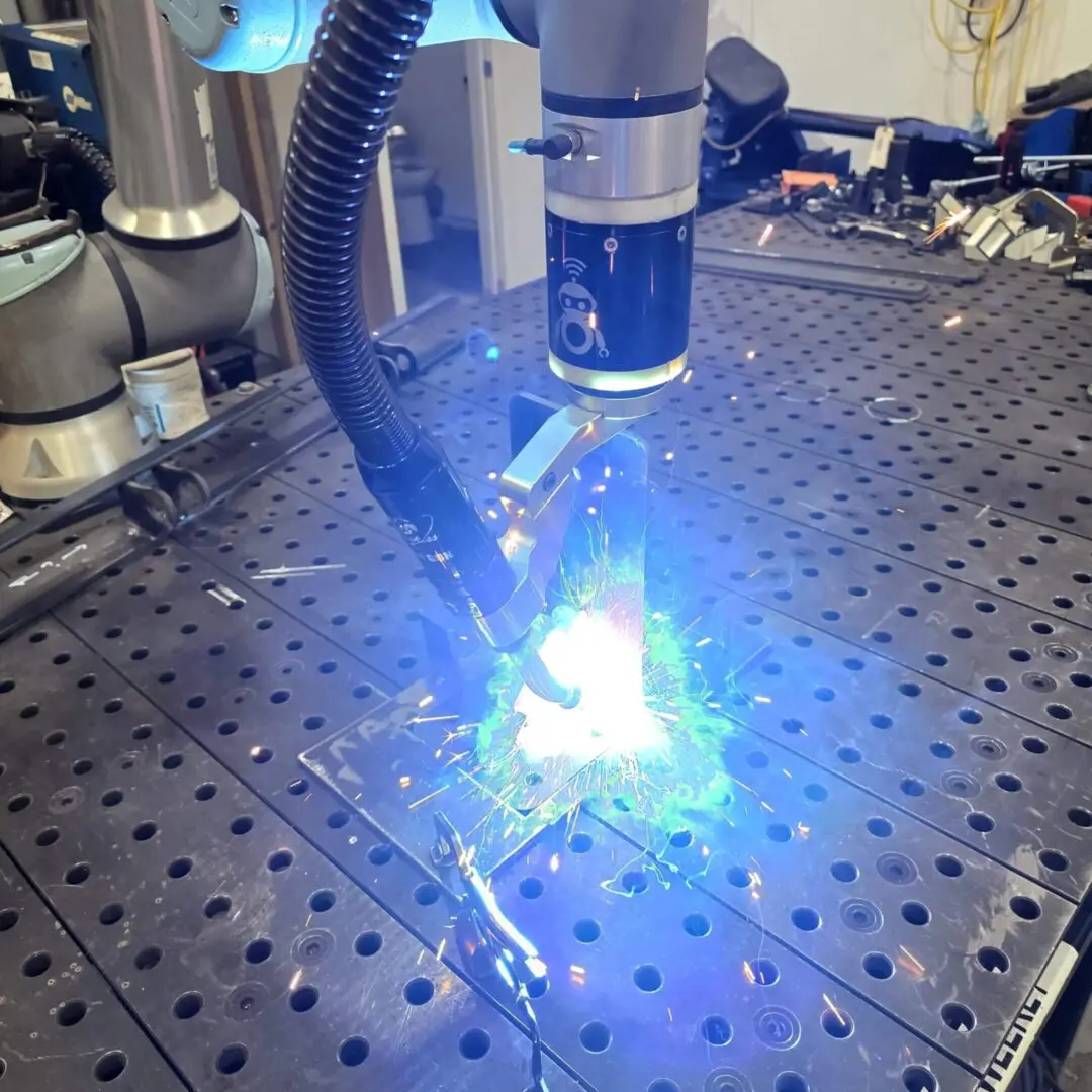 Industrial robot welding metal with bright sparks